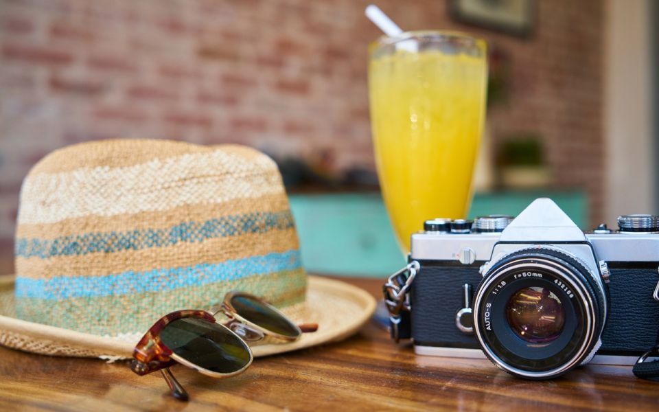 fototoestel drankje hoed en zonnebril